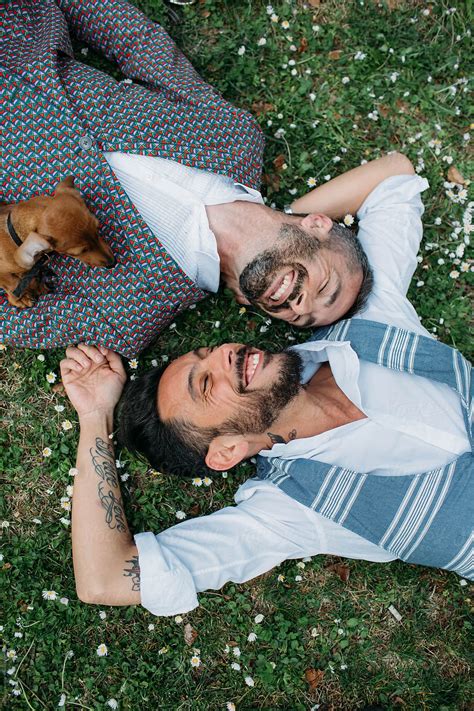 Happy Gay Couple Lying On A Grass By Stocksy Contributor Michela
