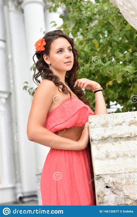 Beautiful Brunette With Curly Hair And Pink Dress Stock