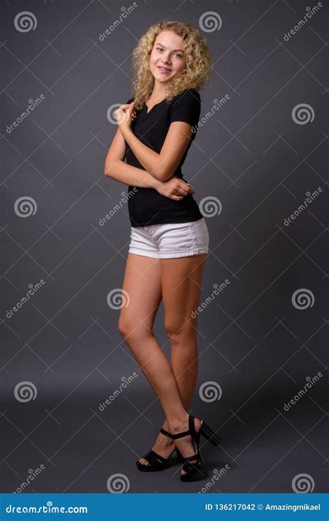 full length portrait  young beautiful woman standing stock photo