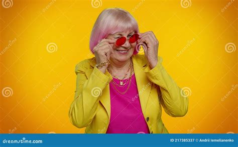 Happy Playful Elderly Granny Woman In Red Sunglasses Blinking Eye