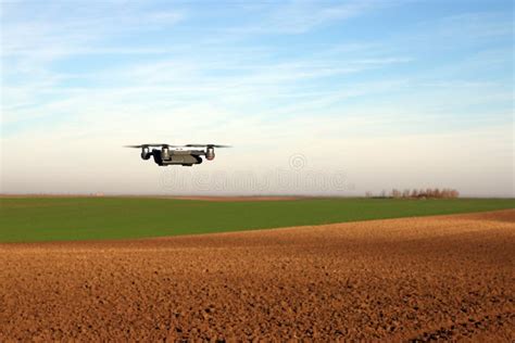 drone  flying   field stock photo image  flying quadrocopter