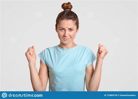 Self Assured Attractive Woman Has Serious Expression Keeps Fists