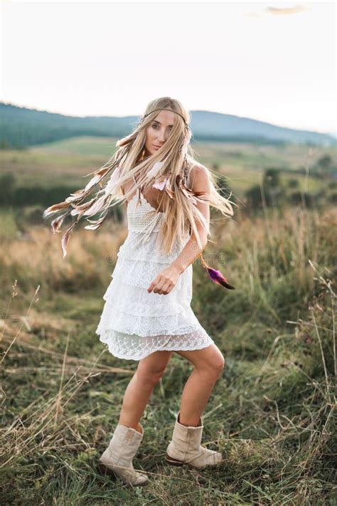 beautiful hippie blonde girl in dress on nature summer field boho
