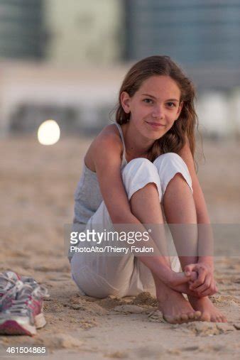 Preteen Girl Sitting On Beach With Barefeet Hugging Knees Photo Getty