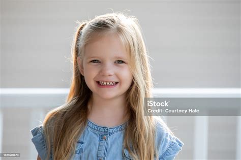 portrait of beautiful kindergarten age girl with blonde hair stock