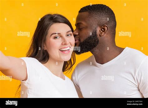 Romantic Multiracial Couple Taking Selfie Loving Black Guy Kissing His