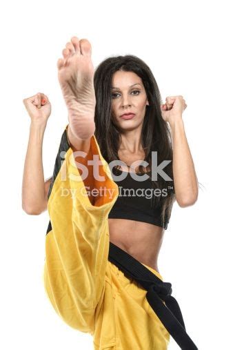 martial artist executing a front kick martial arts women female martial artists martial artist