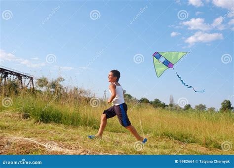 boy flying  kite stock photo image  clouds hobby