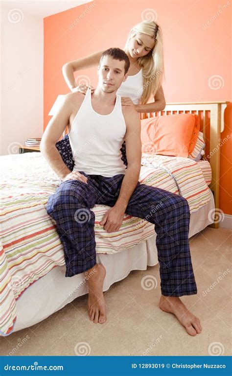 woman massaging man s shoulders in bedroom stock image image of
