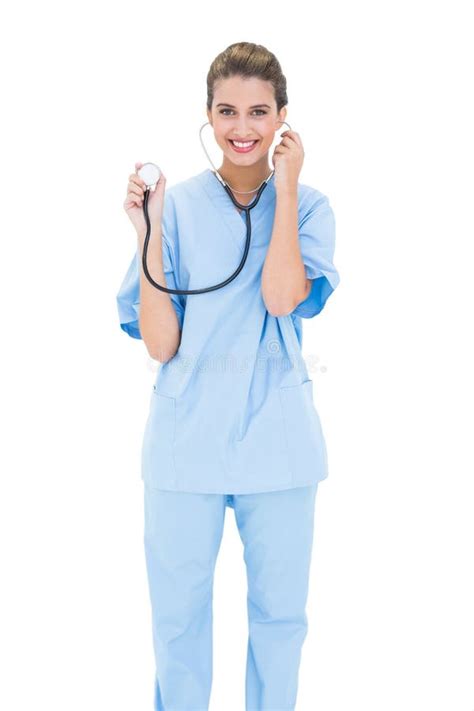 Content Brown Haired Nurse In Blue Scrubs Holding Her Stethoscope Stock