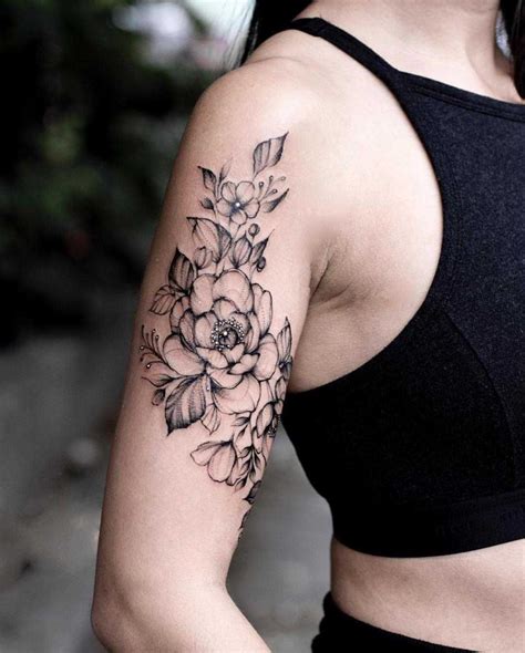 black floral piece    upper arm tattoos  women  sleeve unique  sleeve