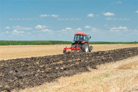 tractor plowing stock photo  fotokostic