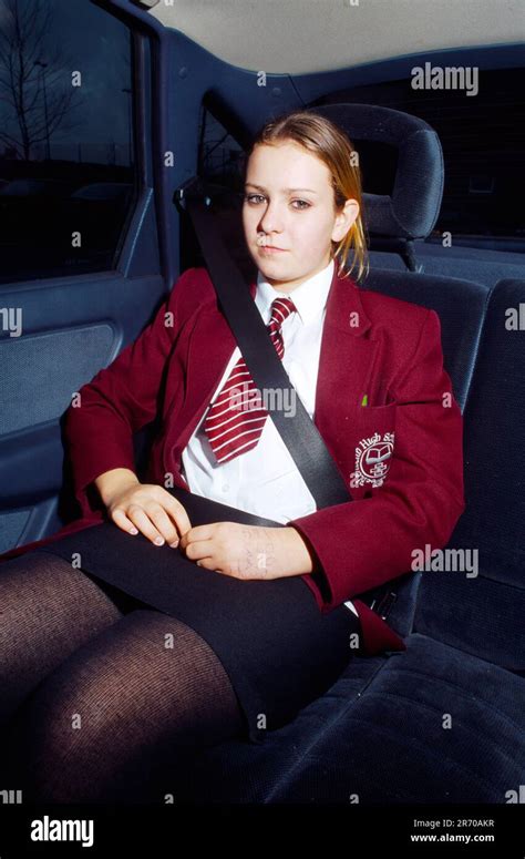 13 Year Old Teenage Girl Wearing Seat Belt Sitting In The Back Of A Car