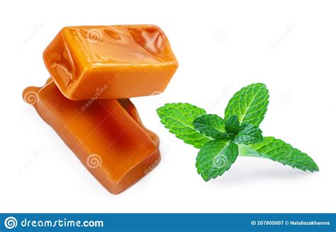 Sweet Caramel Candies With Caramel Sauce And Mint Leaf Isolated On A