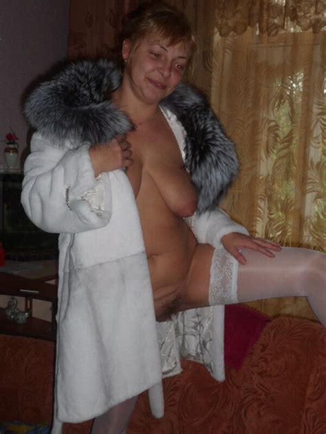 mature woman in a fur coat and stockings