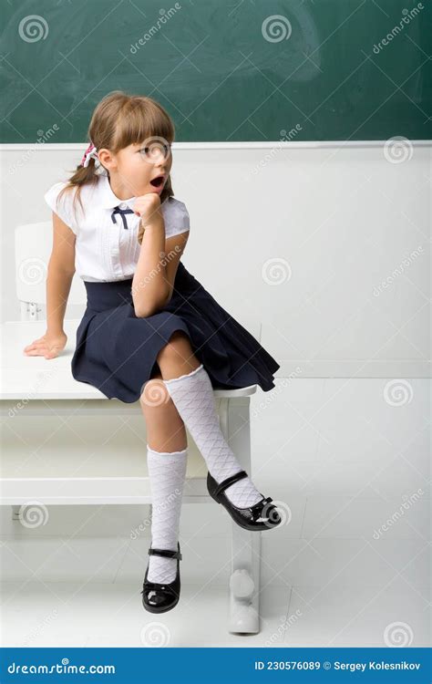 Happy School Girl Sitting On Desk In Classroom Stock Image Image Of