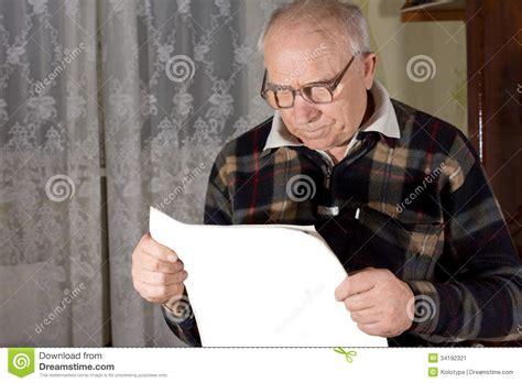 senior man wearing reading glasses stock image image of journal male