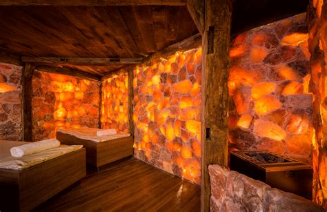 salt cave with massage tables and rustic exposed beams