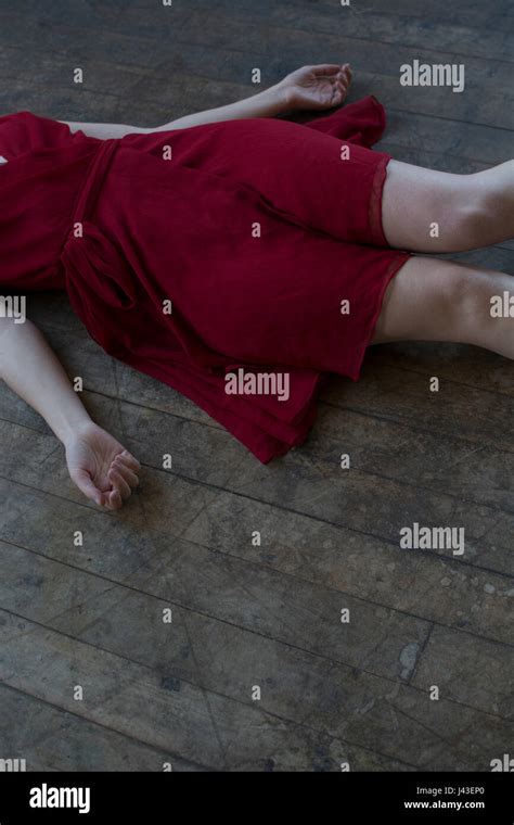 close    dead woman wearing red dress laying    floor stock photo  alamy