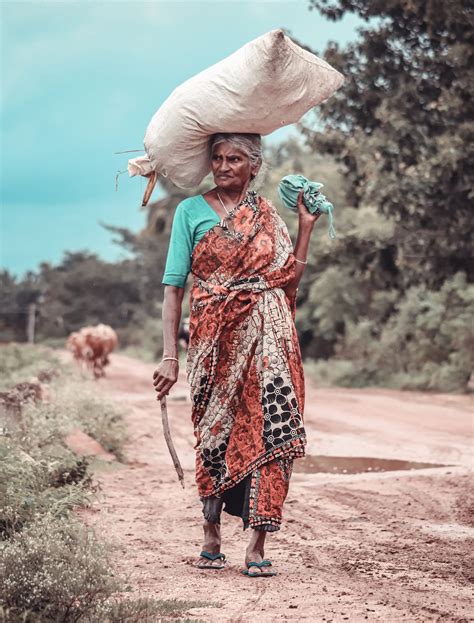 village woman carrying  sack pixahive