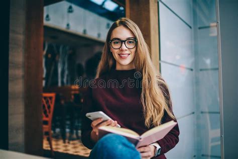 length portrait  attractive female reader standing  cafeteria  literature book