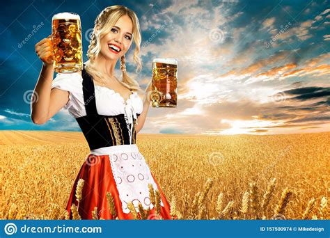happy and smiling bavarian oktoberfest girl waitress in