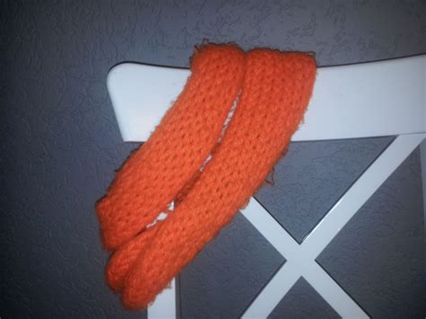 orange scarf  sitting  top   chair