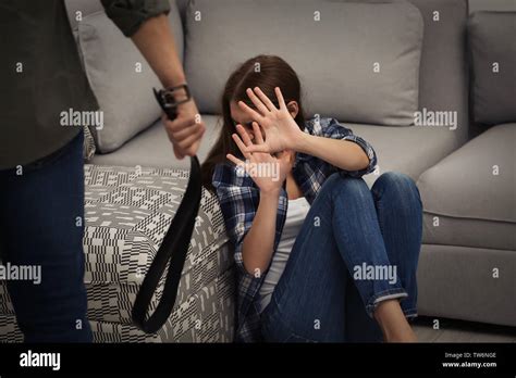 man  belt abusing young woman  home stock photo alamy