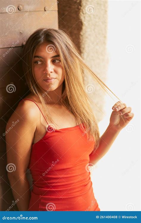 Girl With Tight Red Dress And Long Straight Hair Posing In Toledo Stock