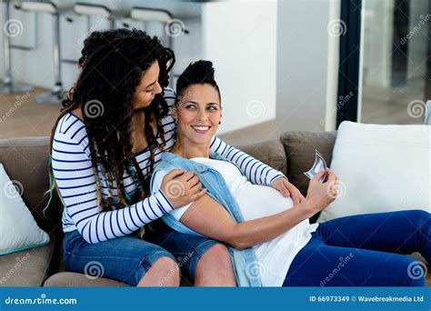 Pregnant Lesbian Couple Looking At Sonography Report Stock Image