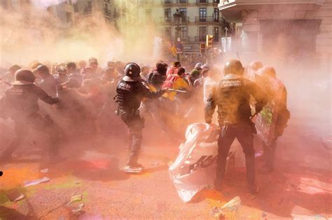 barcelona riot police doused  multi coloured paint  violent clashes  catalonia