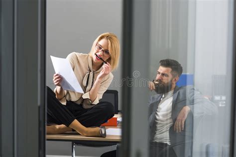 collaboration sensual woman and bearded man work together in office