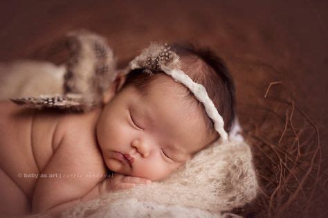 newborn photographer baby wearing wings photographing babies