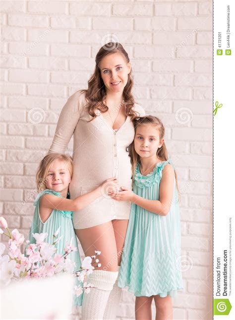 beautiful pregnant woman with two daughters stock image image 41731201