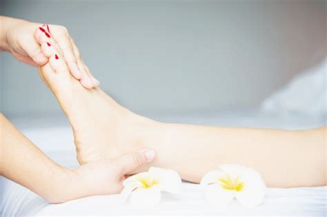 woman receiving foot massage service from masseuse close