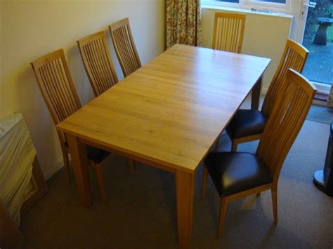 extendable light oak solid wood dining table  chairs  good