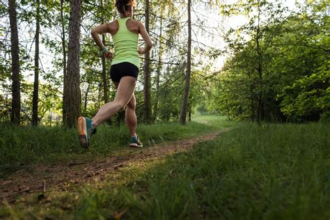 athletic woman running   forest stock photo pixeltote