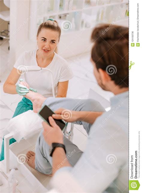 Blonde Haired Massage Therapist Talking To Her Constant Client Stock