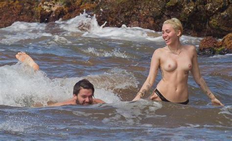 hot miley cyrus topless at the beach showing full tits