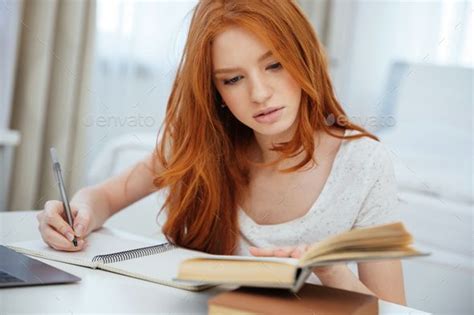 Redhead Woman Doing Homework By Vadymvdrobot Attractive Redhead Woman