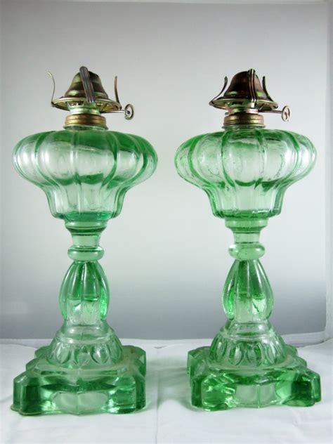 vintage pair of green depression glass kerosene lamps