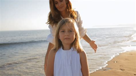 mother cuddling daughter on beach stock footage sbv 300614509 storyblocks