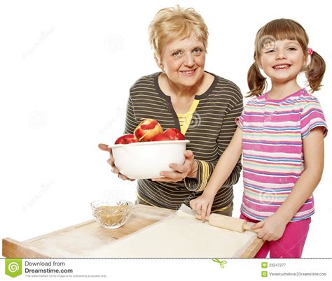 Grandmother And Granddaughter Baking Apple Pie Royalty Free Stock