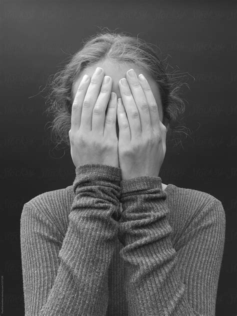portrait of teenage girl with hands covering face close up by rialto