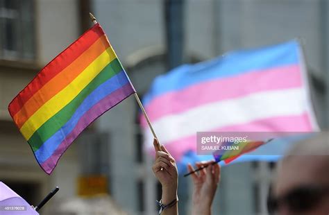 People Hold Up Rainbow Flags As They Demonstrate During The Lesbian