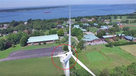 drone captures man sunbathing   wind turbine