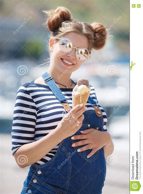 pregnant woman with ice cream cone near the ocean stock image image
