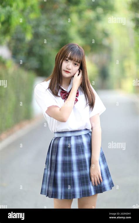 Beautiful Asian Japanese School Girl Uniform Looking At Park Outdoor