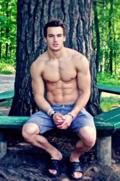 shirtless male beefcake muscular physique in shorts sitting tree photo