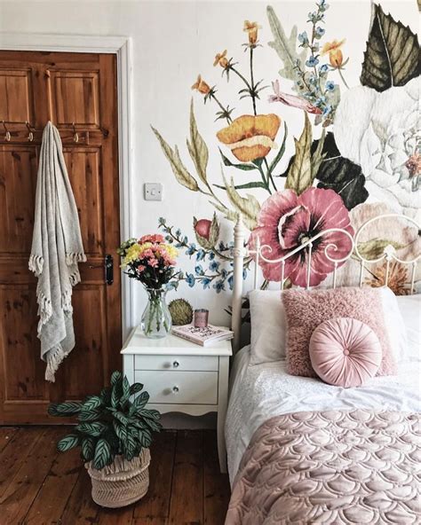 A Beautiful Floral Wallpaper Mural In The Bedroom With Pink Accents